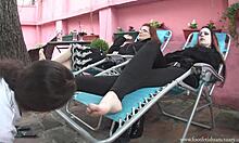 Two babes chilling in recliners and get their feet licked