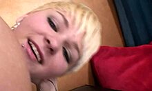 Short-haired blonde stripping and masturbating