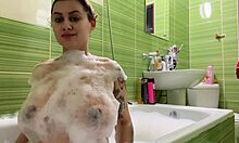 Büyük göğüsleri ve çekici kalçaları olan hamile bir genç banyo yapıyor